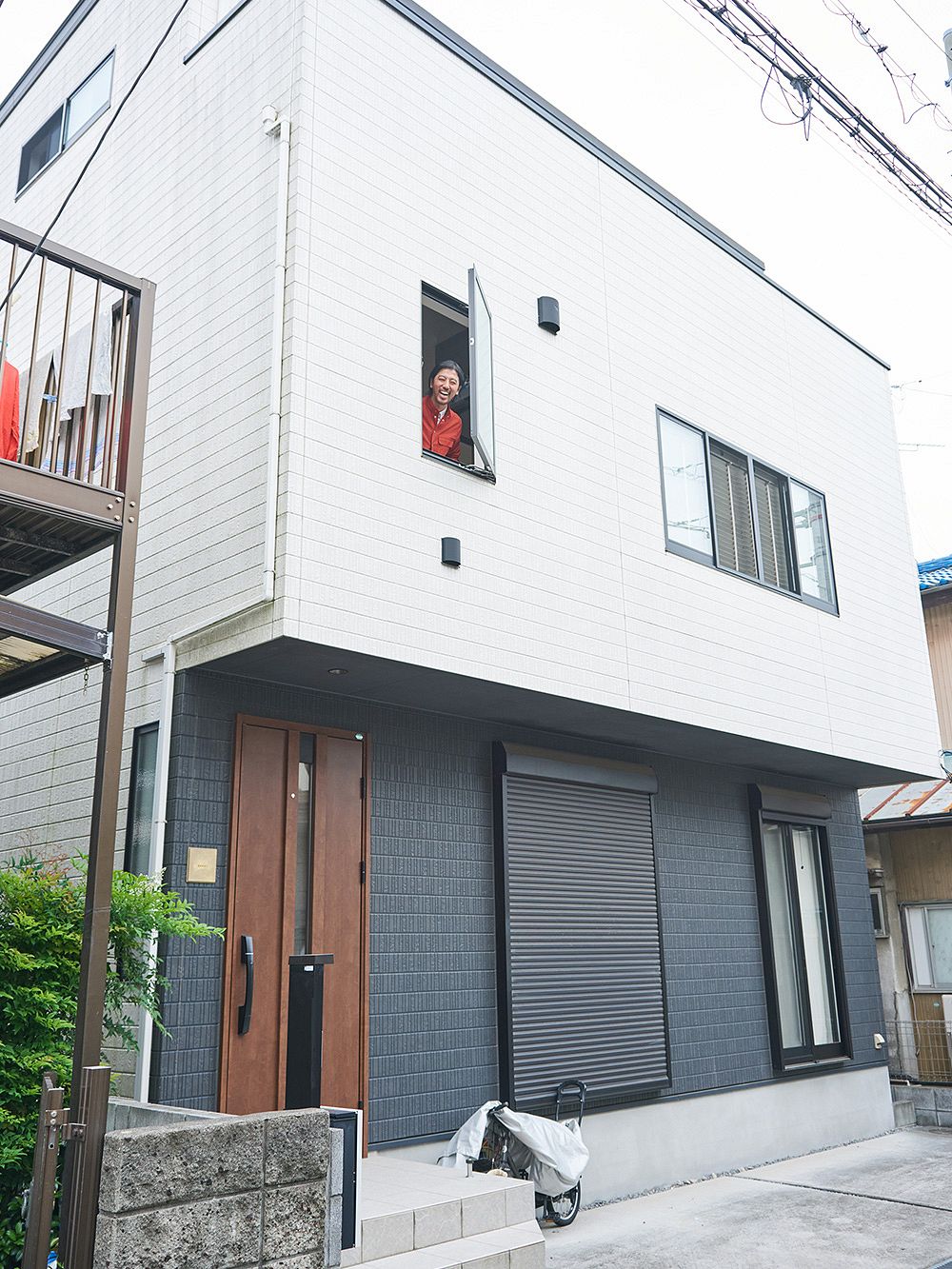 A man smiling at the window