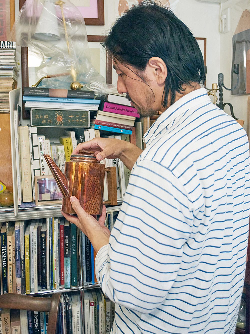 Takeshi holding a copper teapot