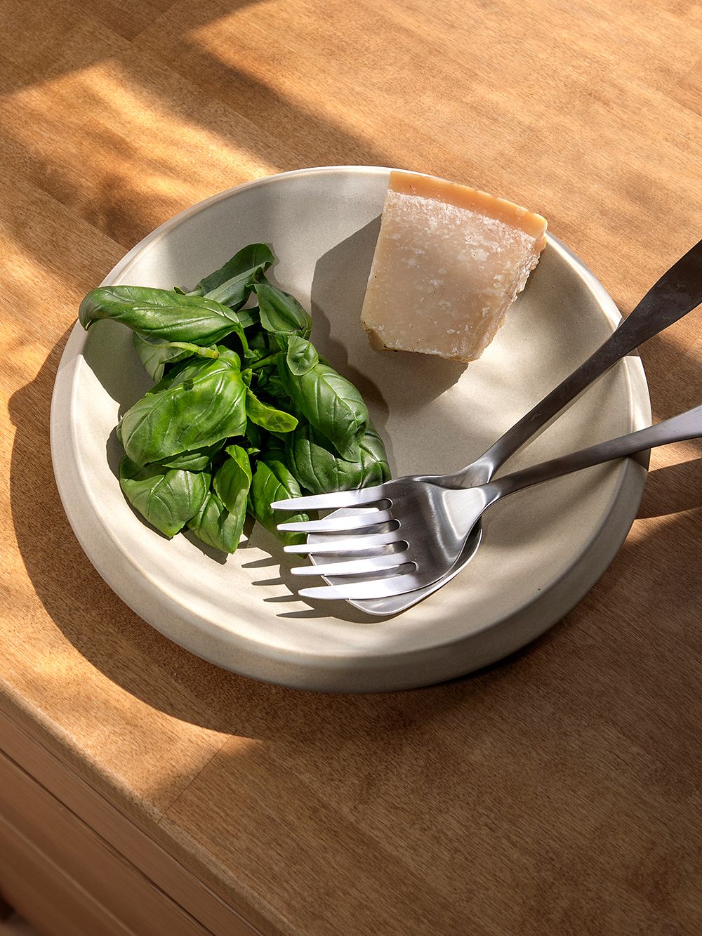 Basil and pecorino cheese on a plate